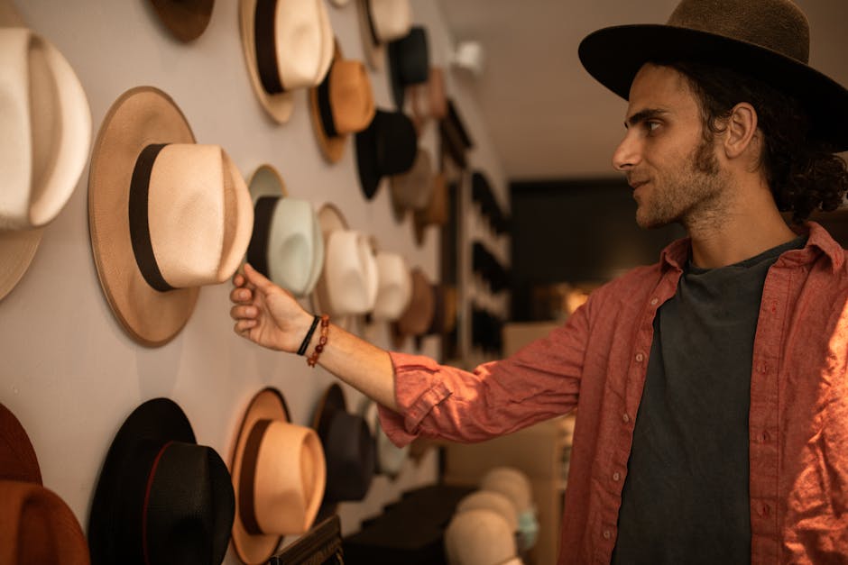 Man shopping for hats in a stylish indoor boutique store with a variety of options on display.