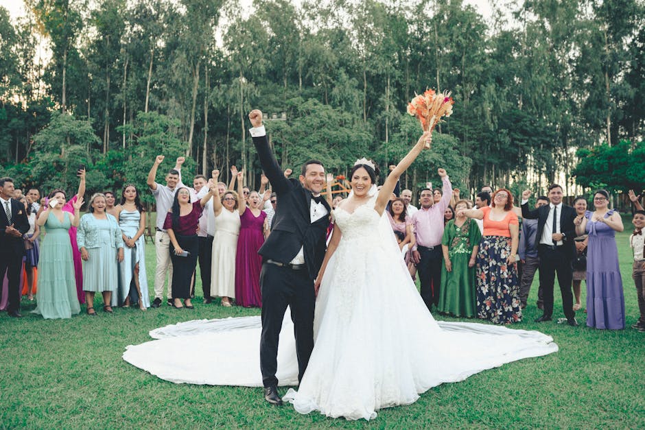 Bride and groom celebrate with guests outdoors in a vibrant summer wedding ceremony.